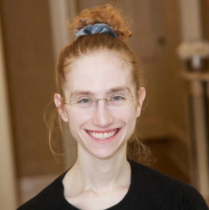 Portrait photo of person smiling with red hair and fair skin